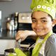 Nice little kid in chef hat at kitchen